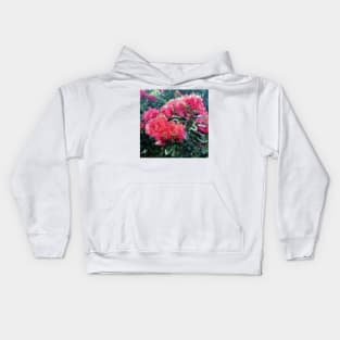 Red flower blossoms amid lush green foliage Kids Hoodie